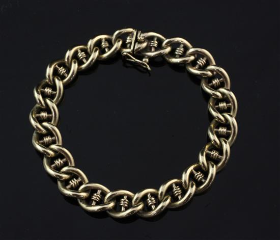 A gold curb and coil link bracelet, 6.75in.